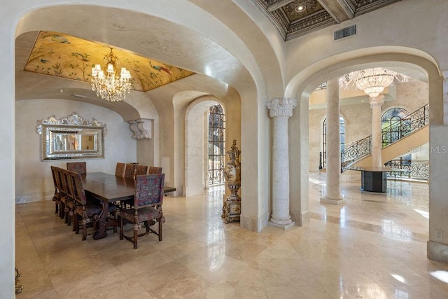 tiled dining room featuring plenty of natural light, coffered ceiling, a chandelier, and ornate columns