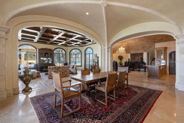 dining area with a notable chandelier, coffered ceiling, and light tile flooring