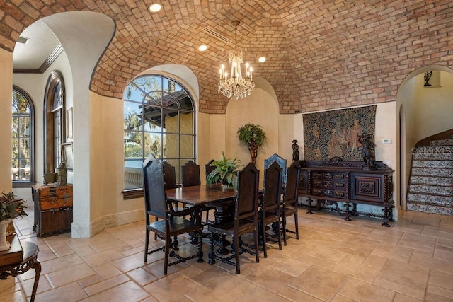 dining room featuring light tile flooring, crown molding, brick ceiling, and an inviting chandelier