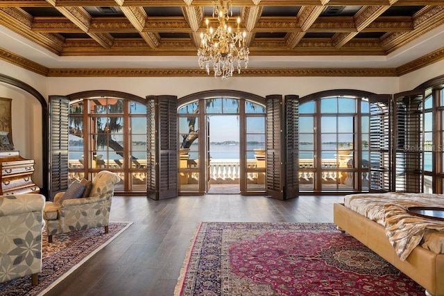 interior space featuring crown molding, a water view, and coffered ceiling