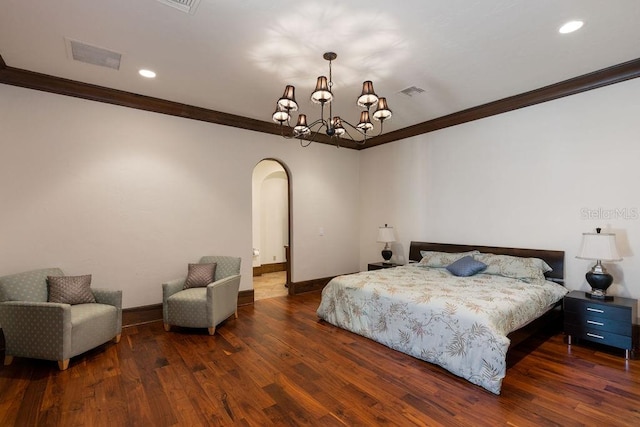 bedroom featuring crown molding, dark hardwood / wood-style floors, and a chandelier