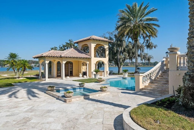 view of swimming pool with a patio and an in ground hot tub