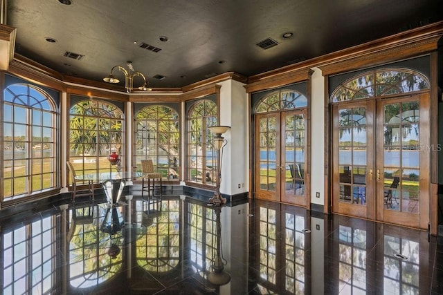 unfurnished sunroom featuring an inviting chandelier