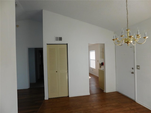 unfurnished dining area with lofted ceiling, a chandelier, and dark hardwood / wood-style flooring