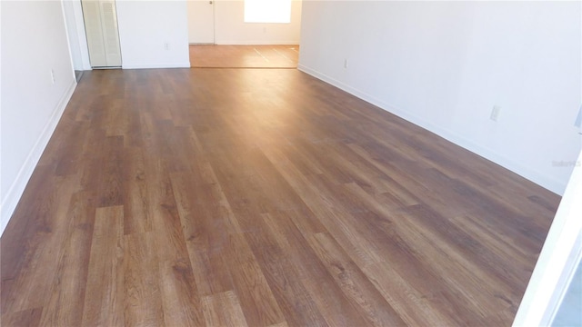 unfurnished room with dark hardwood / wood-style floors