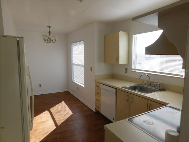 kitchen featuring dark wood-type flooring, white appliances, a notable chandelier, sink, and pendant lighting