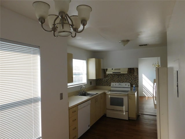 kitchen with tasteful backsplash, dark wood-type flooring, white appliances, wall chimney exhaust hood, and sink