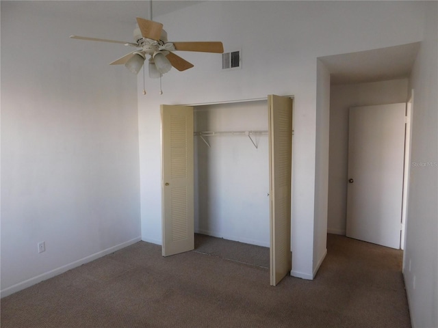 unfurnished bedroom featuring a closet, ceiling fan, and dark carpet