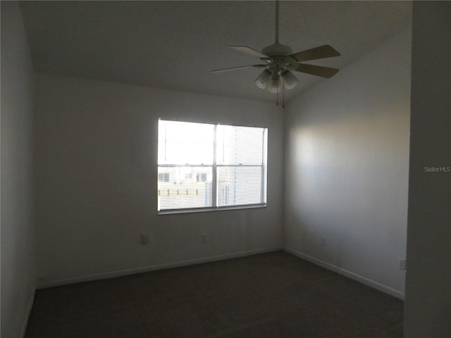 carpeted empty room featuring ceiling fan and lofted ceiling