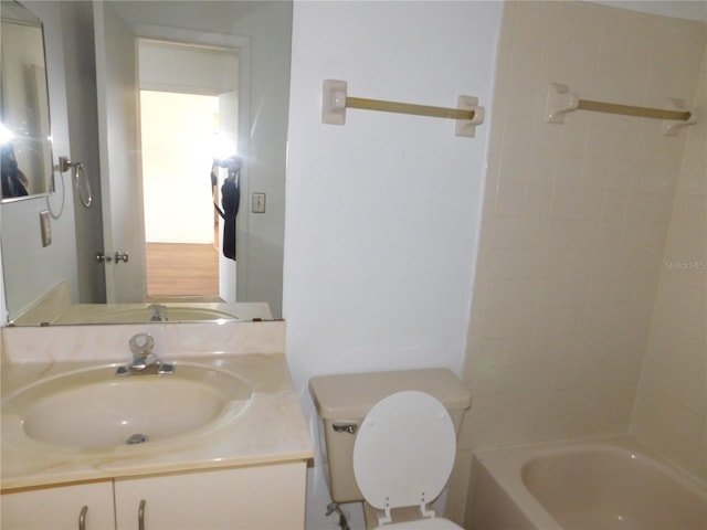 full bathroom with toilet, tiled shower / bath combo, and vanity