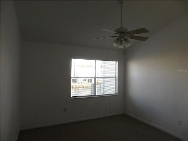 carpeted empty room with ceiling fan and lofted ceiling