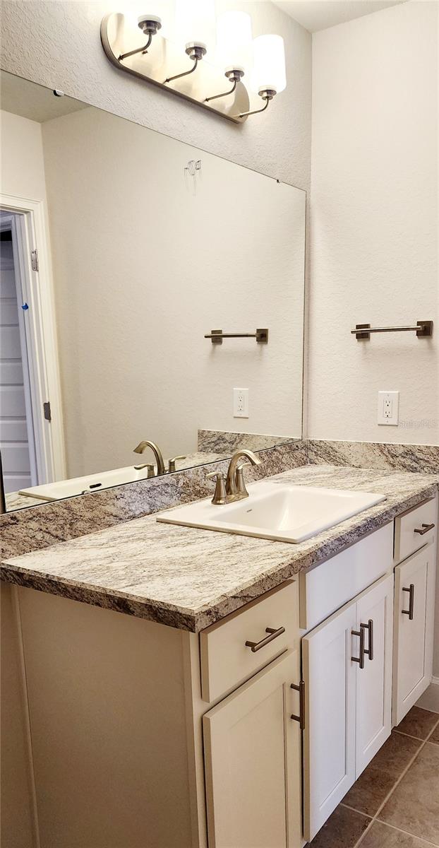 bathroom featuring tile patterned flooring and vanity