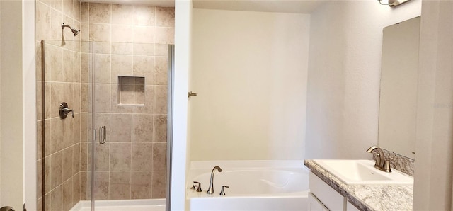 bathroom featuring vanity and independent shower and bath