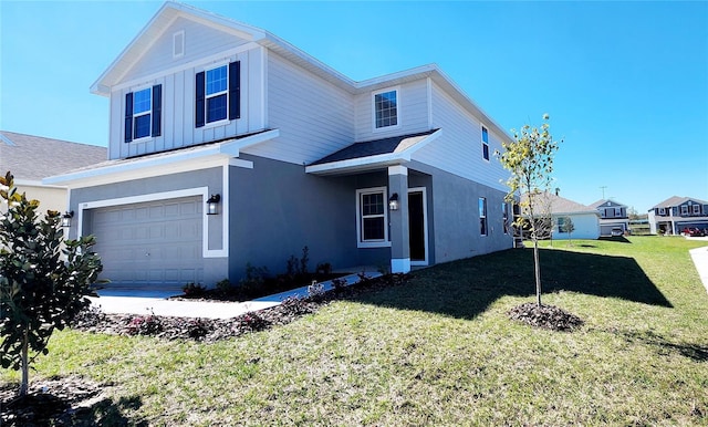 view of front of property featuring a garage and a front lawn