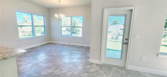 entryway featuring an inviting chandelier