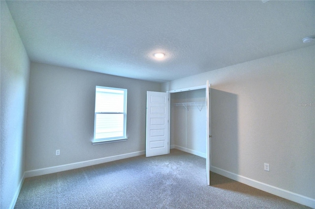 unfurnished bedroom featuring a closet, a textured ceiling, and carpet floors