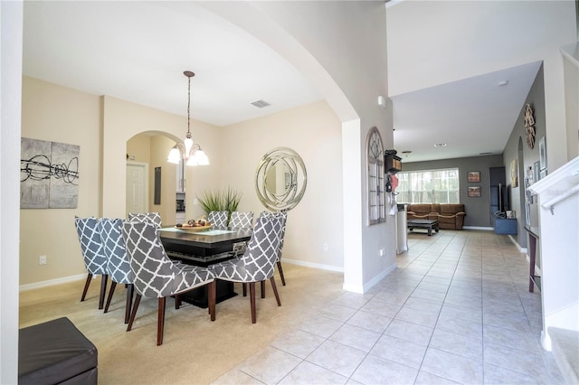 dining space with light tile floors and a notable chandelier