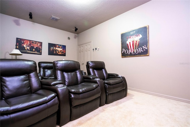 home theater with light carpet and a textured ceiling