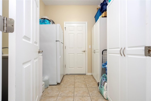 laundry area with light tile flooring