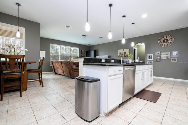 kitchen featuring decorative light fixtures, white cabinetry, stainless steel dishwasher, and light tile floors