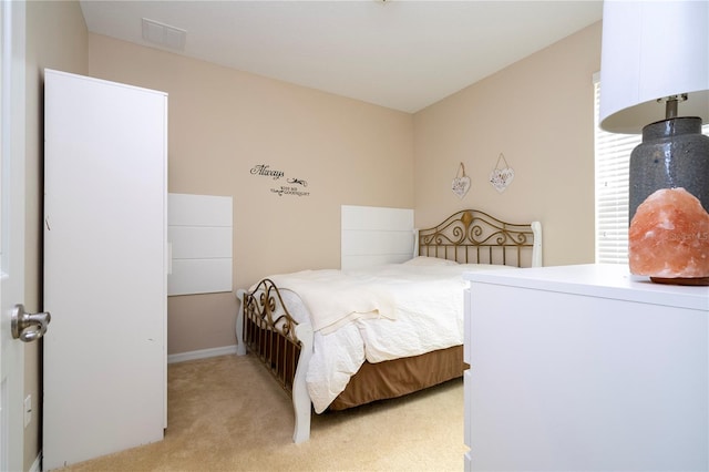 bedroom featuring light colored carpet