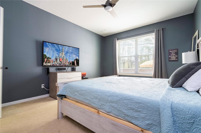 bedroom featuring light carpet and ceiling fan