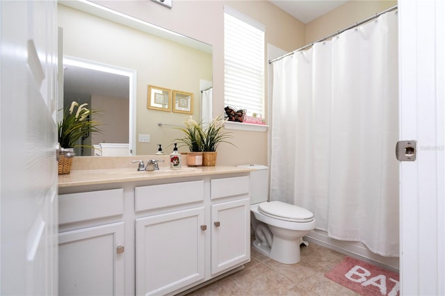 bathroom featuring toilet, tile floors, and vanity