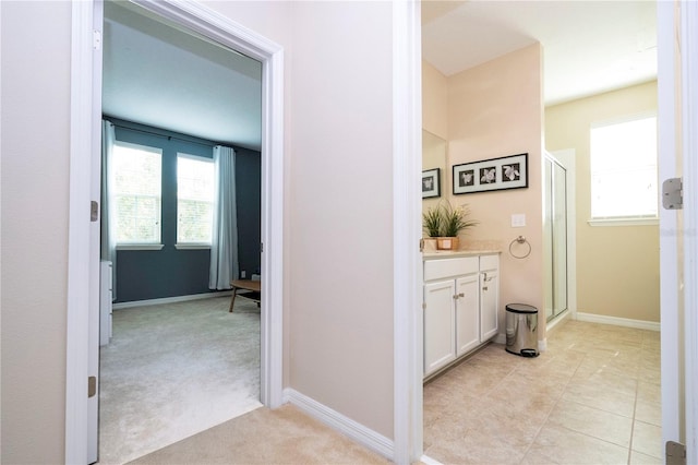 bathroom featuring an enclosed shower, tile floors, a healthy amount of sunlight, and vanity