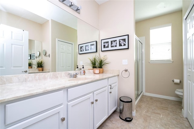 bathroom featuring vanity, tile floors, a shower with door, and toilet