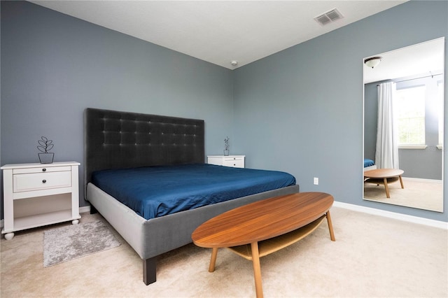 bedroom with light colored carpet