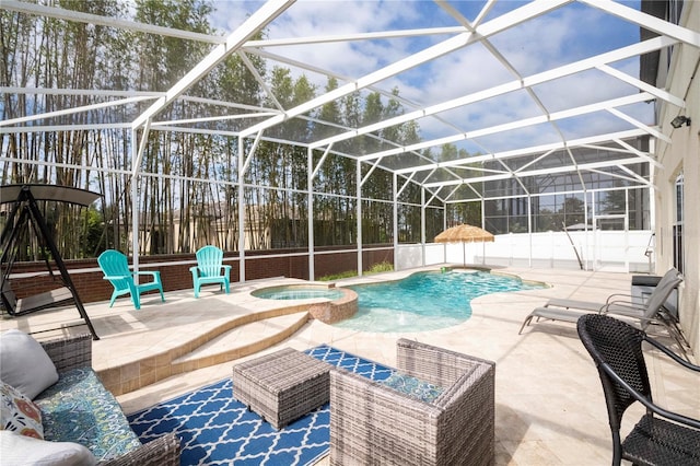 view of pool with a patio, an in ground hot tub, and a lanai