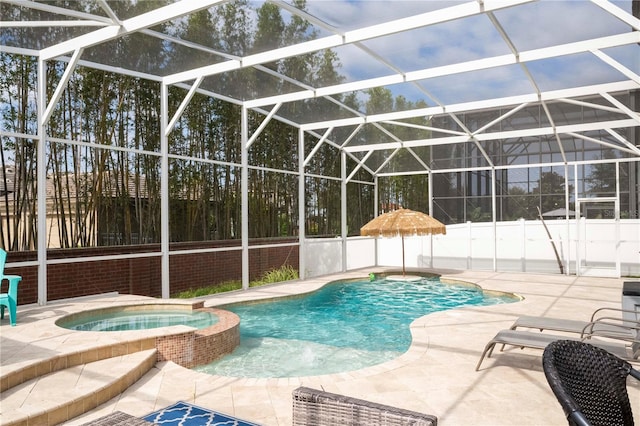 view of swimming pool with a patio, an in ground hot tub, and a lanai