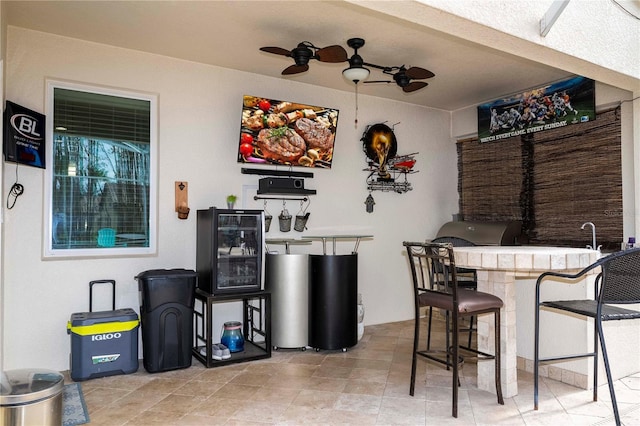 view of terrace featuring ceiling fan and exterior bar