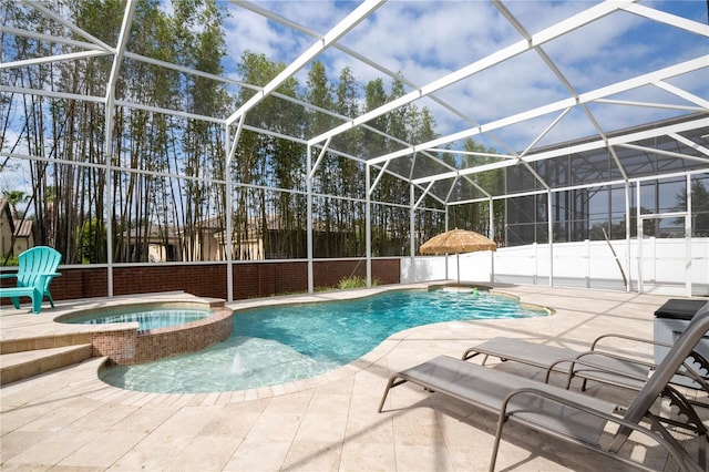 view of pool featuring an in ground hot tub, pool water feature, glass enclosure, and a patio area