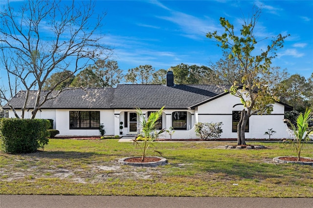 single story home featuring a front lawn