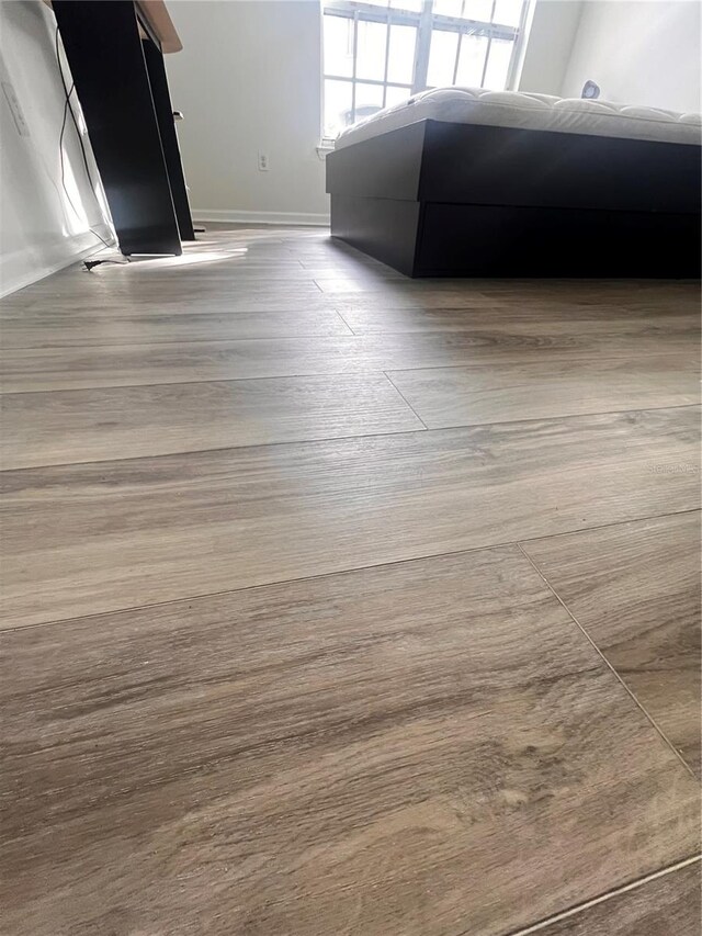 room details with baseboards and wood finished floors