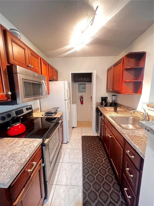 kitchen featuring a sink, light countertops, appliances with stainless steel finishes, a textured ceiling, and open shelves