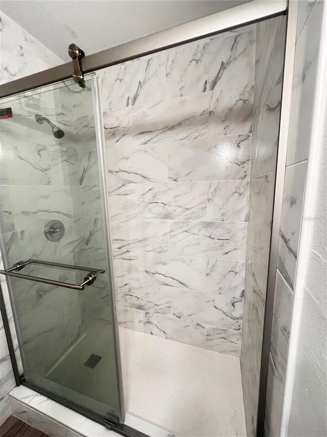 full bath with a marble finish shower