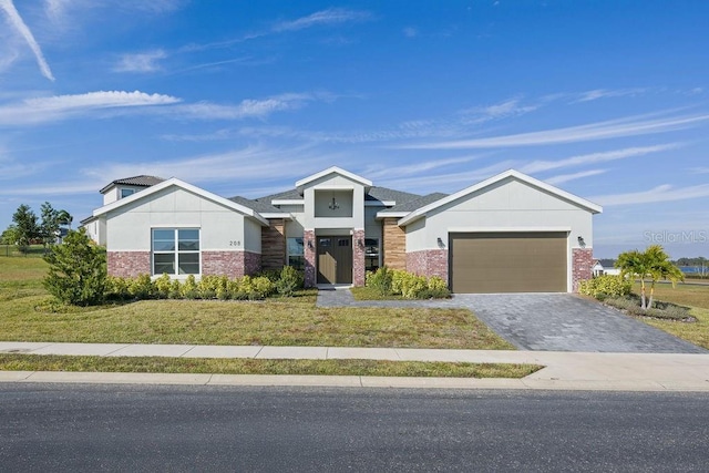 view of front of property featuring a garage and a front yard