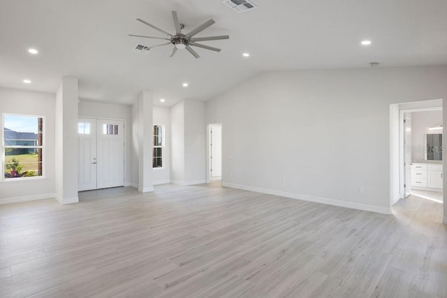 unfurnished living room featuring lofted ceiling, ceiling fan, and light hardwood / wood-style flooring