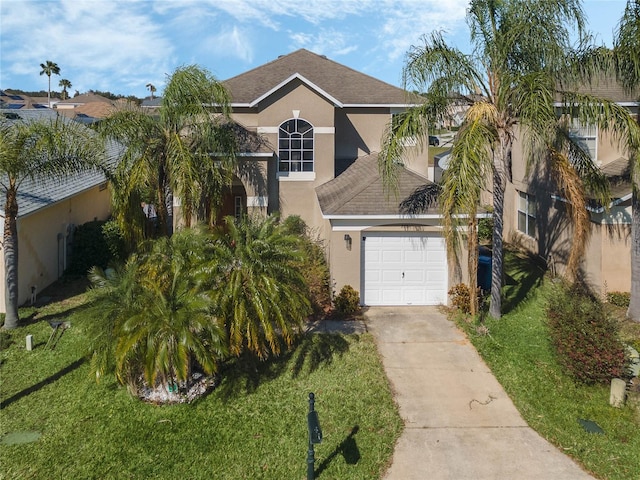 view of front of home with a front yard and a garage