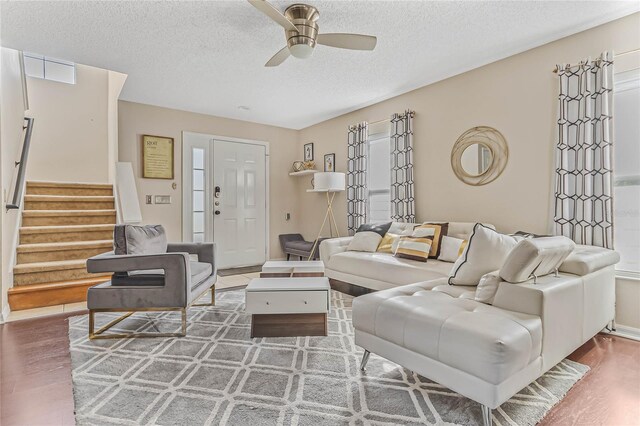 2881 Kokomo Loop, Haines City, FL 33844 - living room with ceiling fan, a textured ceiling, and dark hardwood / wood-style flooring