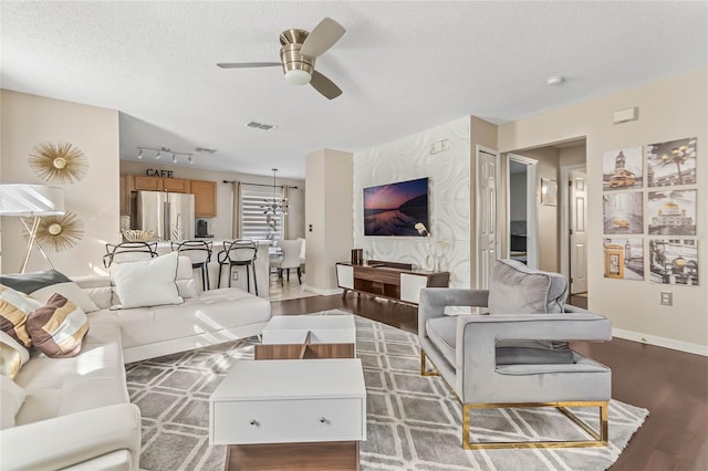 2881 Kokomo Loop, Haines City, FL 33844 - living room featuring dark hardwood / wood-style floors, a textured ceiling, ceiling fan, and rail lighting