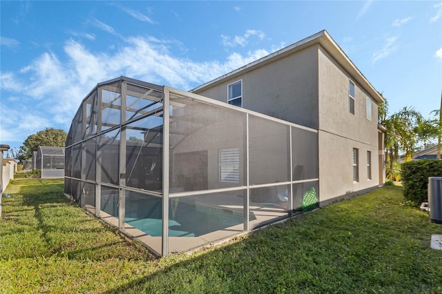 2881 Kokomo Loop, Haines City, FL 33844 - rear view of property featuring a yard and a lanai