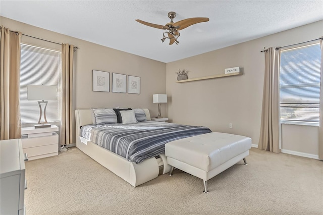 2881 Kokomo Loop, Haines City, FL 33844 - bedroom with light colored carpet, ceiling fan, and multiple windows