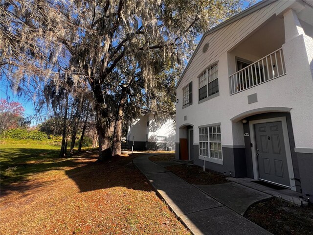 view of side of home with a balcony