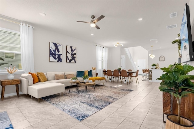 tiled living room featuring ceiling fan