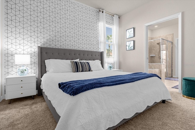 bedroom featuring dark colored carpet and ensuite bathroom