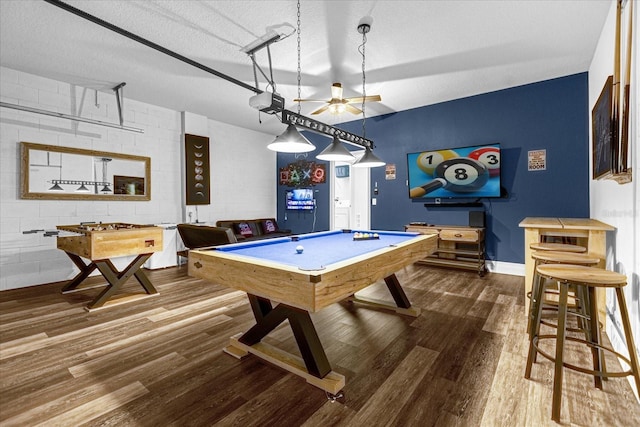 rec room featuring dark wood-type flooring, a textured ceiling, ceiling fan, and pool table