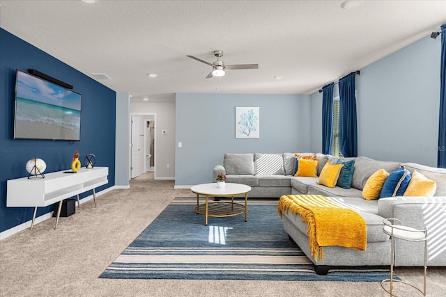 carpeted living room with a textured ceiling and ceiling fan